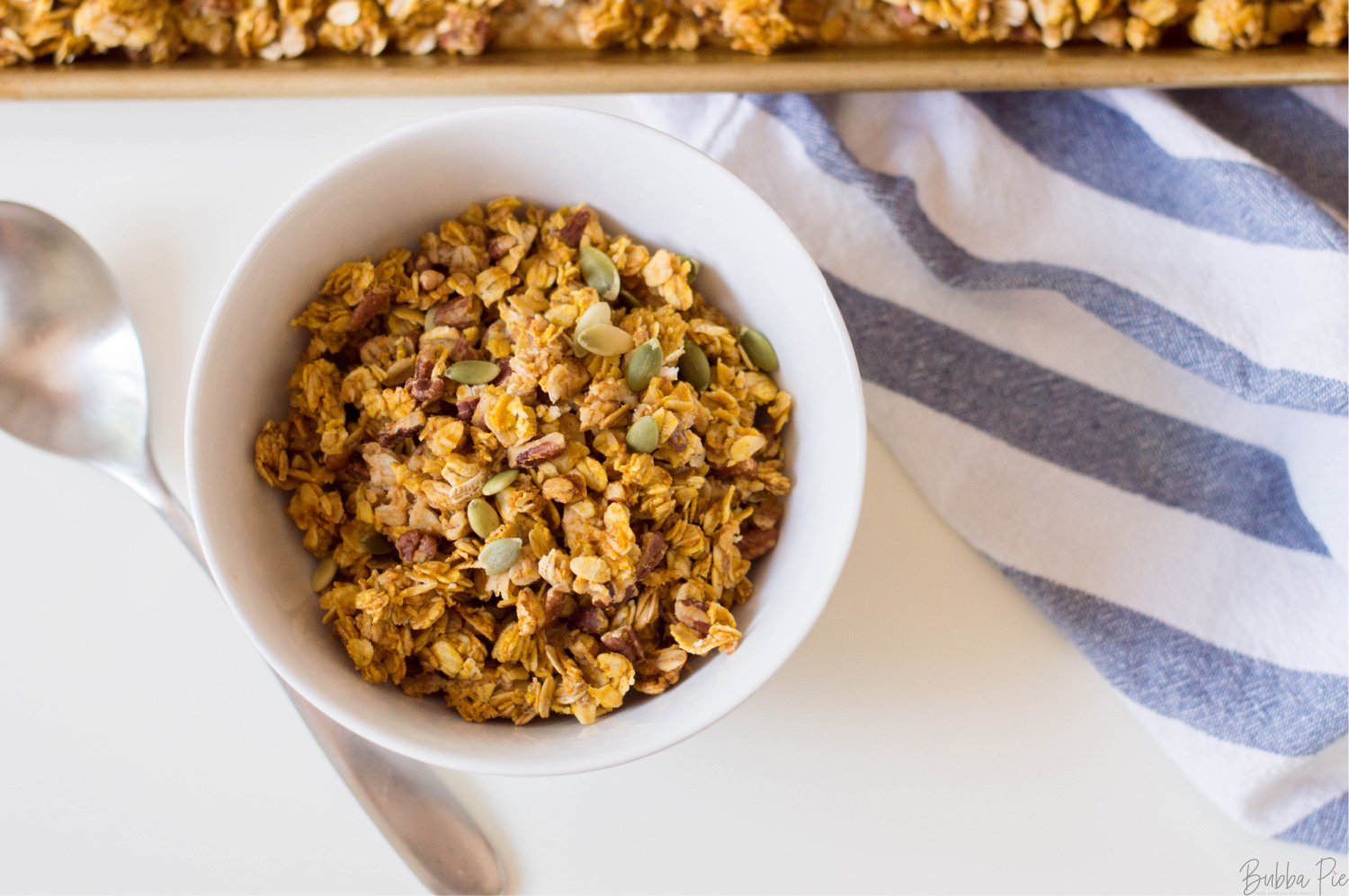 Homemade Pumpkin Granola being served in a white bowl.