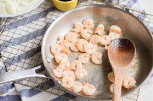 Sauteing Shrimp in a skillet to make mei fun with noodles.