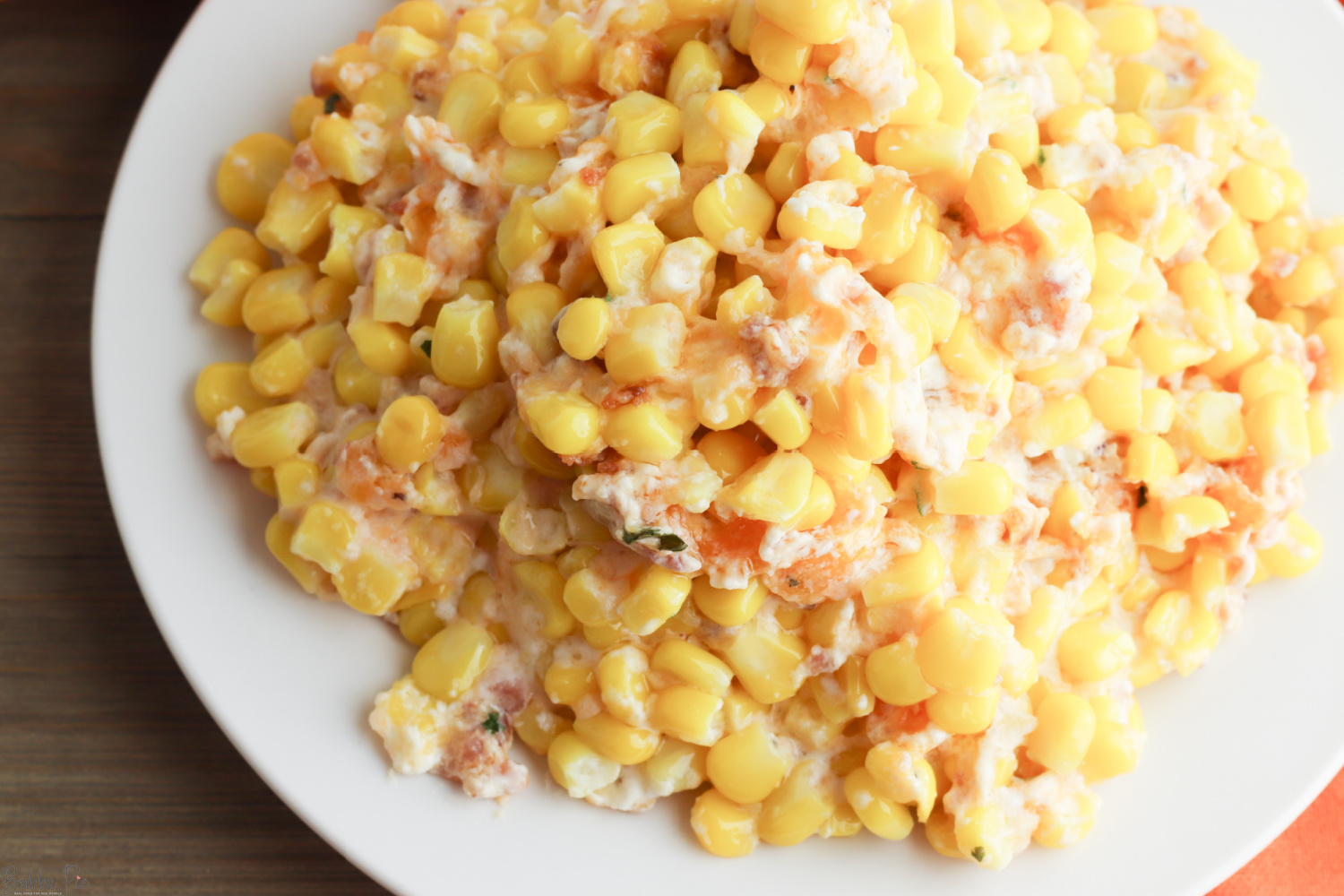 Corn Casserole with Cream Cheese being served on a white plate.