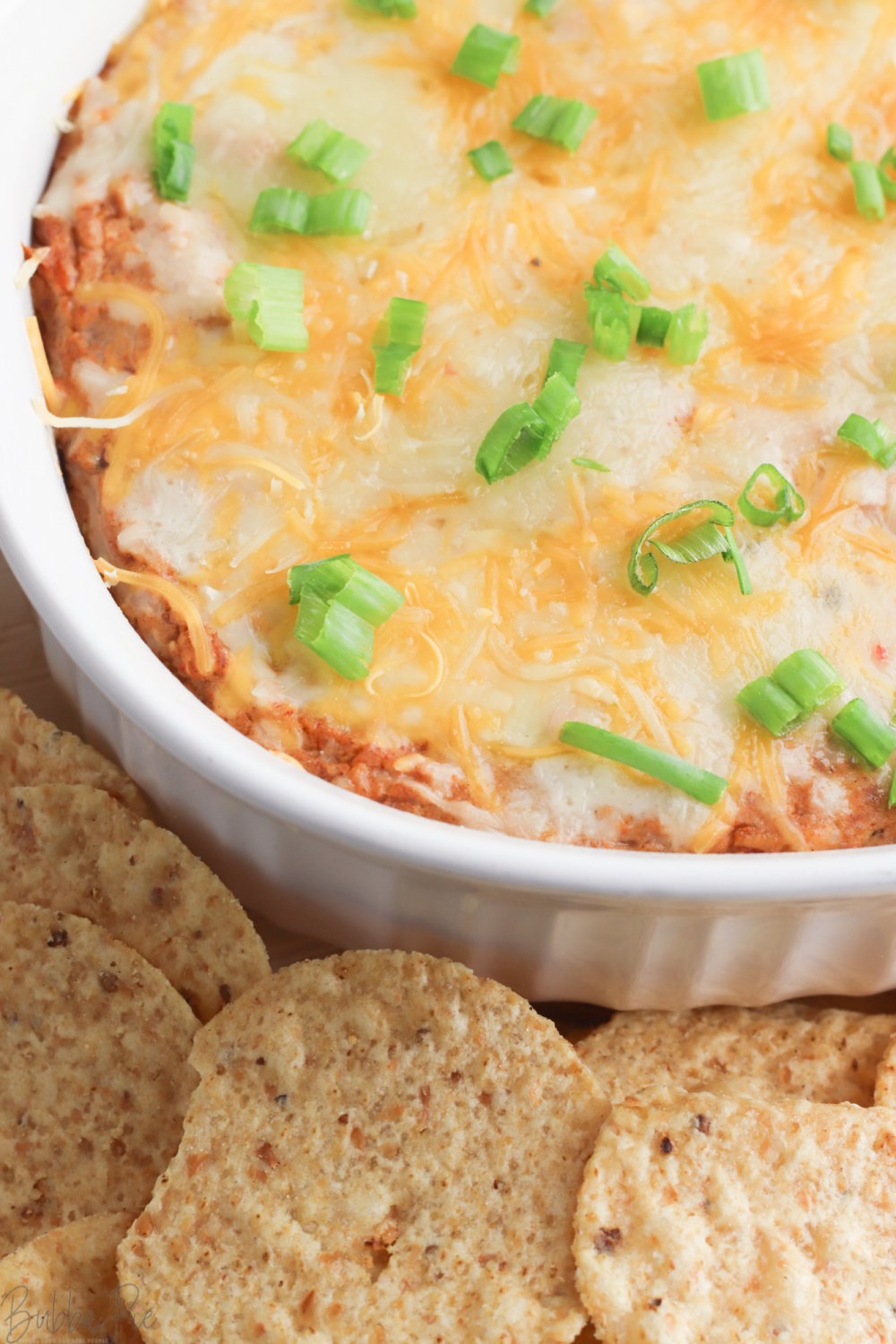 Cream Cheese Bean Dip in a casserole dish with tortilla chips for dipping.