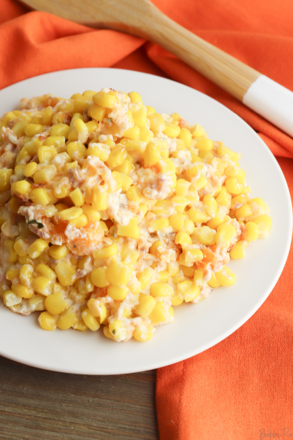 Cream Cheese Corn Casserole with Bacon being served as a side dish.