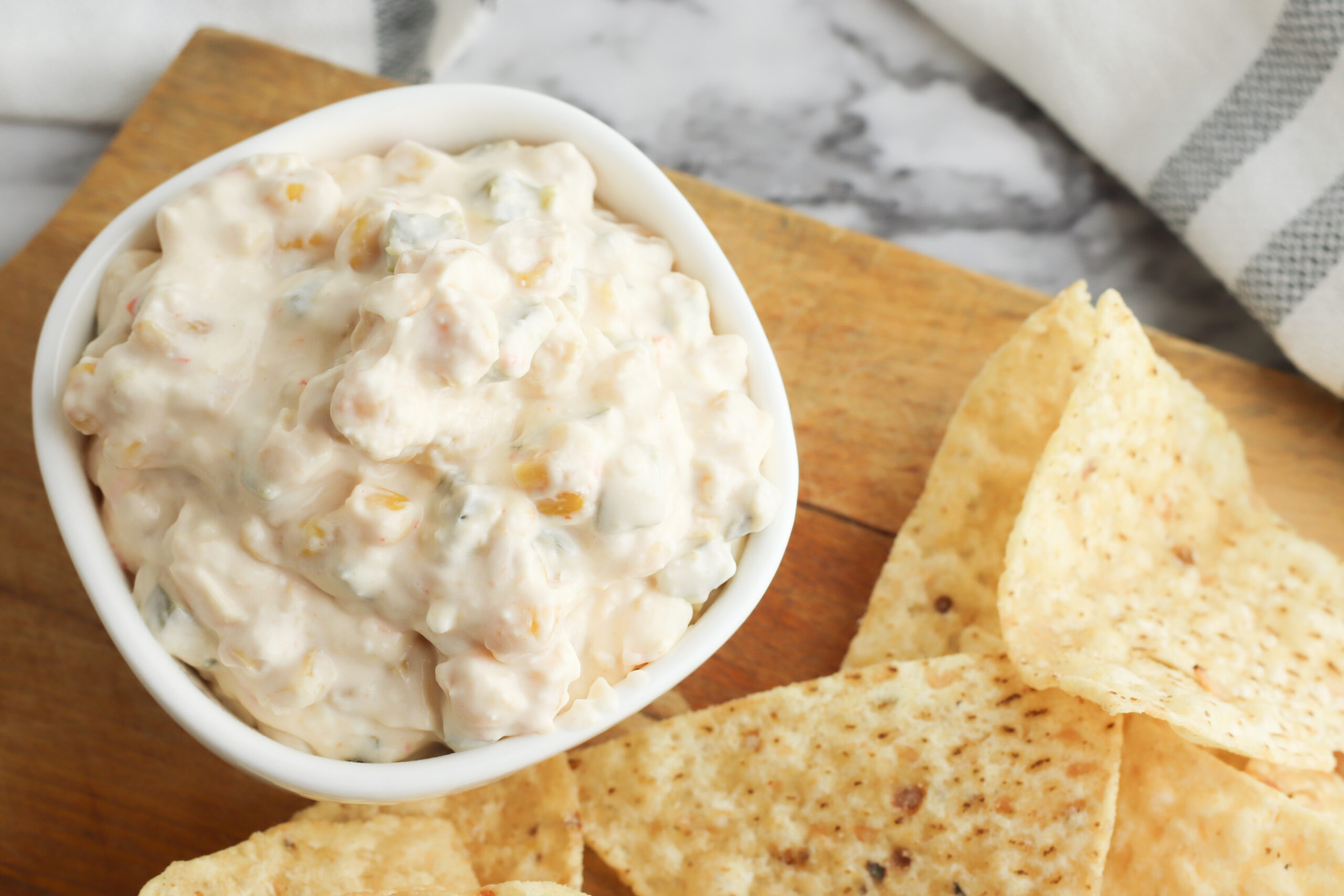 Fiesta Corn Dip being served on a platter with Tortilla Chips