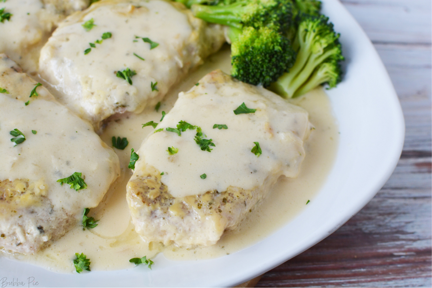 Slow Cooker Ranch Pork Chops being served for dinner with Broccoli