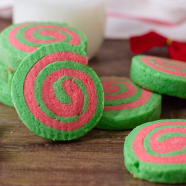 Christmas Pinwheel Cookies served with holiday decorations and a glass of milk.