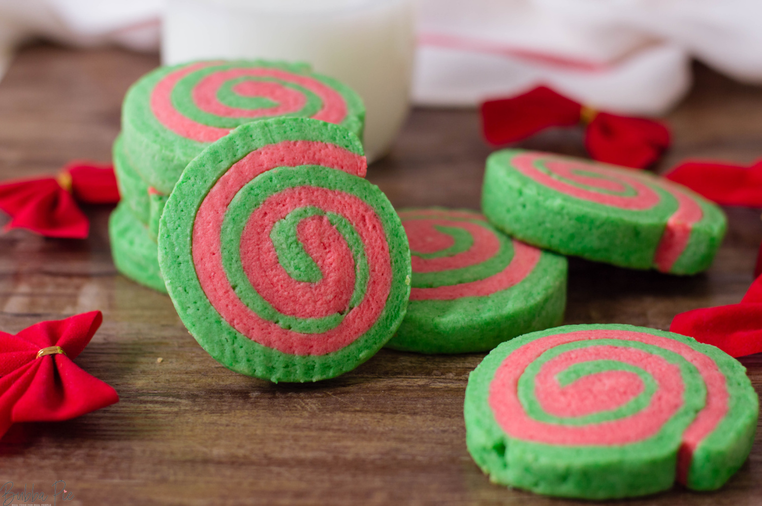 Christmas Pinwheel Cookies served with holiday decorations and a glass of milk.