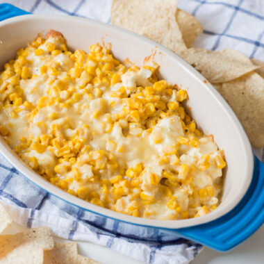 Hot Corn Dip being served in a bowl as an appetizer at a party.