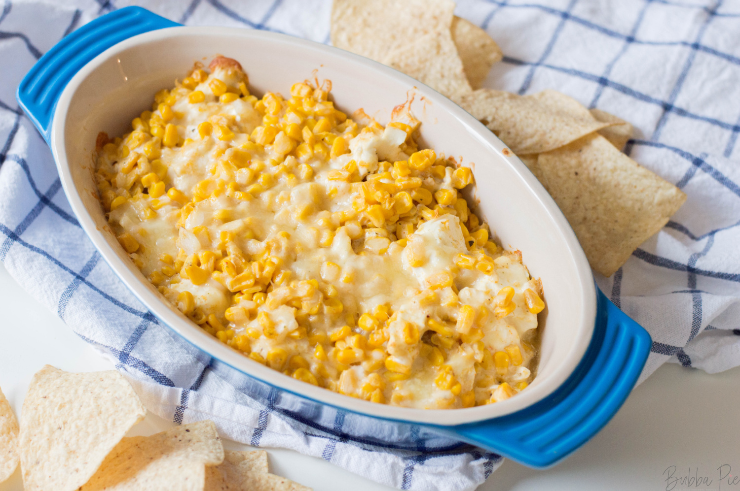 Hot Corn Dip being served in a bowl as an appetizer at a party.