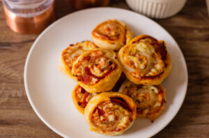 Pepperoni Pinwheels being served on a plate at a party.