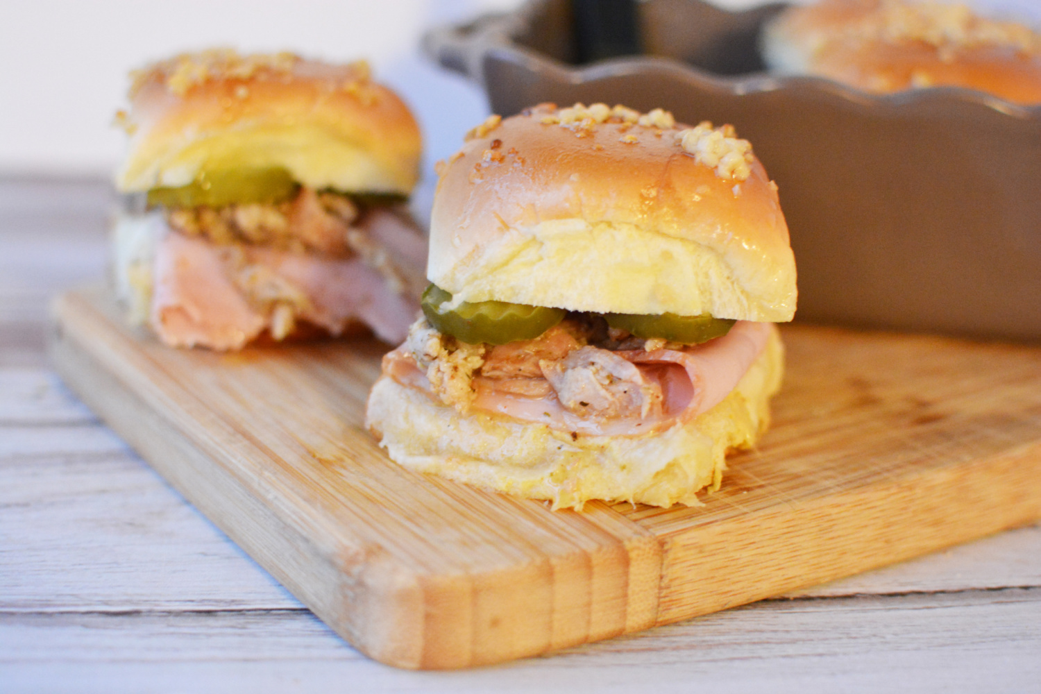 Cuban Sliders being served on a wooden board. 