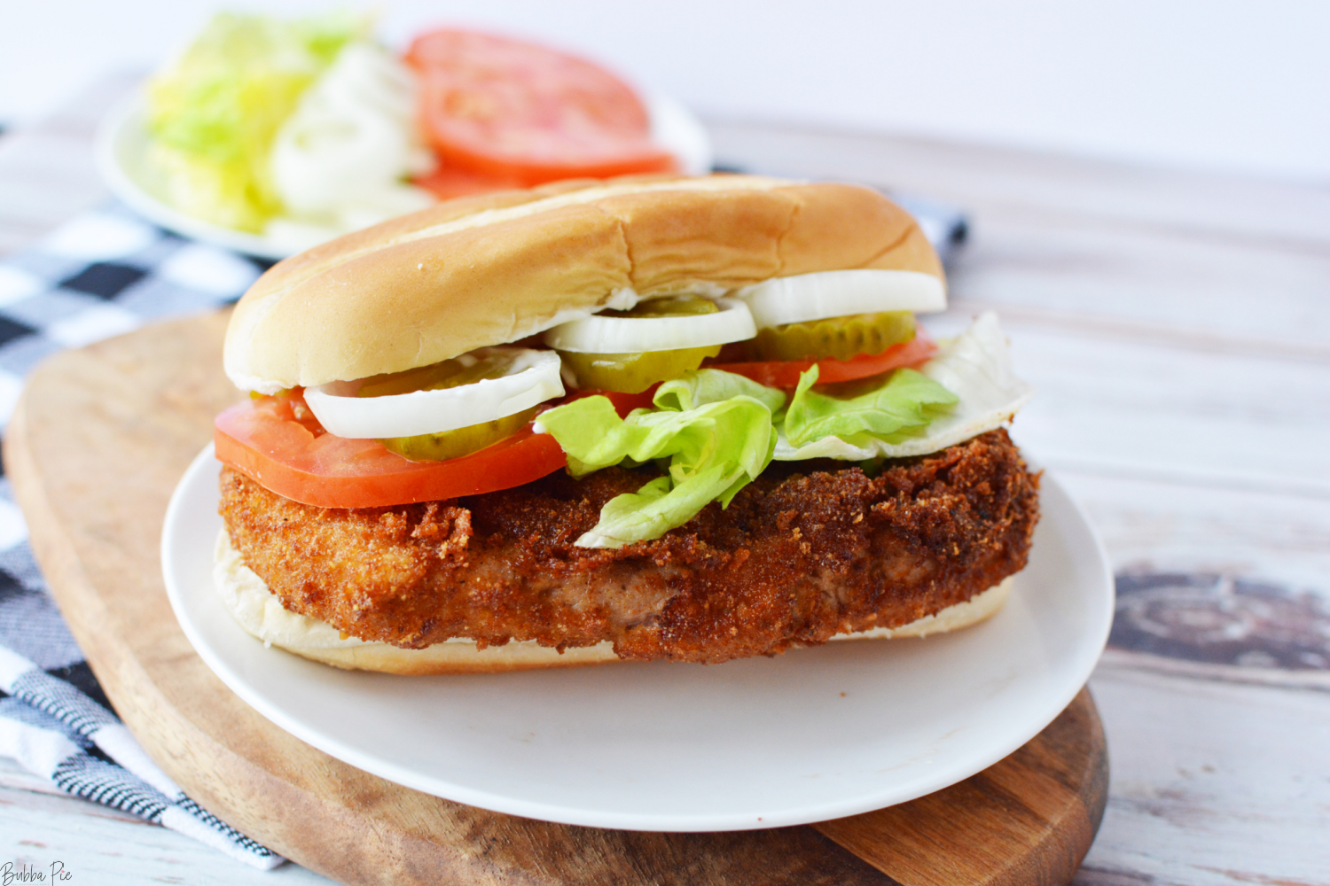 Indiana Pork Tenderloin Sandwich being served on a plate.