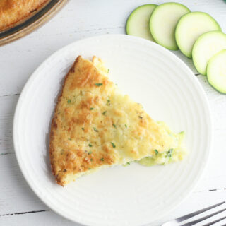 Bisquick Zucchini Quiche being served on a white plate.