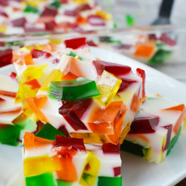 Easy Broken Glass Jello squares stacked on a white plate.