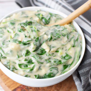Easy Creamed Spinach Recipe being eaten as a side dish.