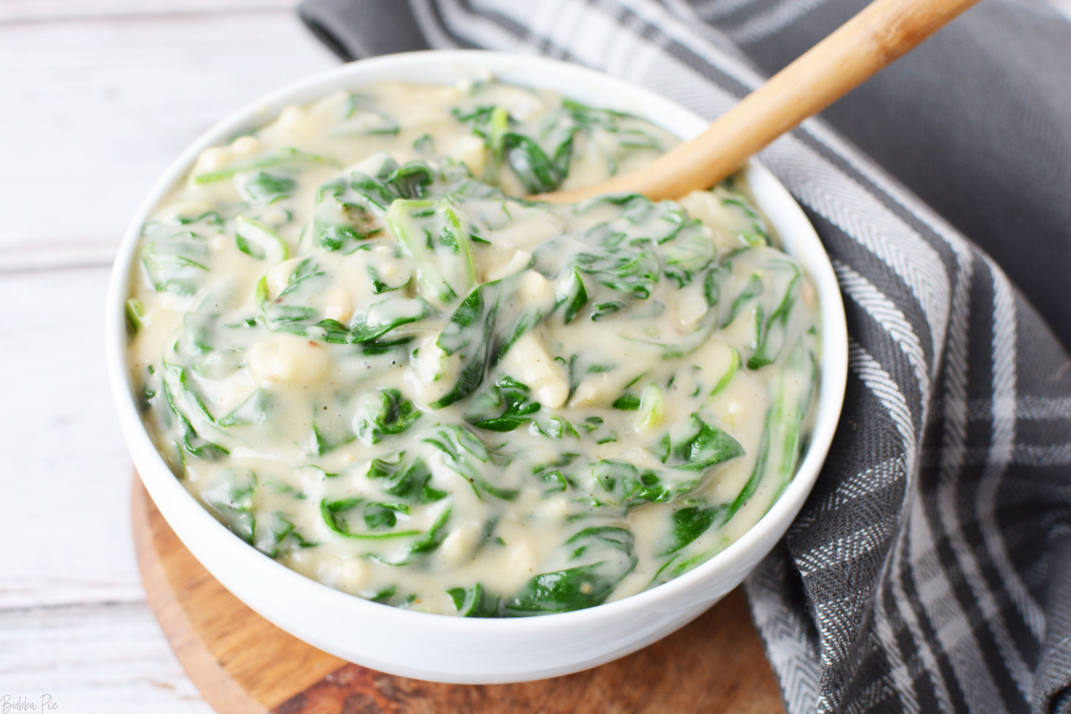 Easy Creamed Spinach Recipe being eaten as a side dish.
