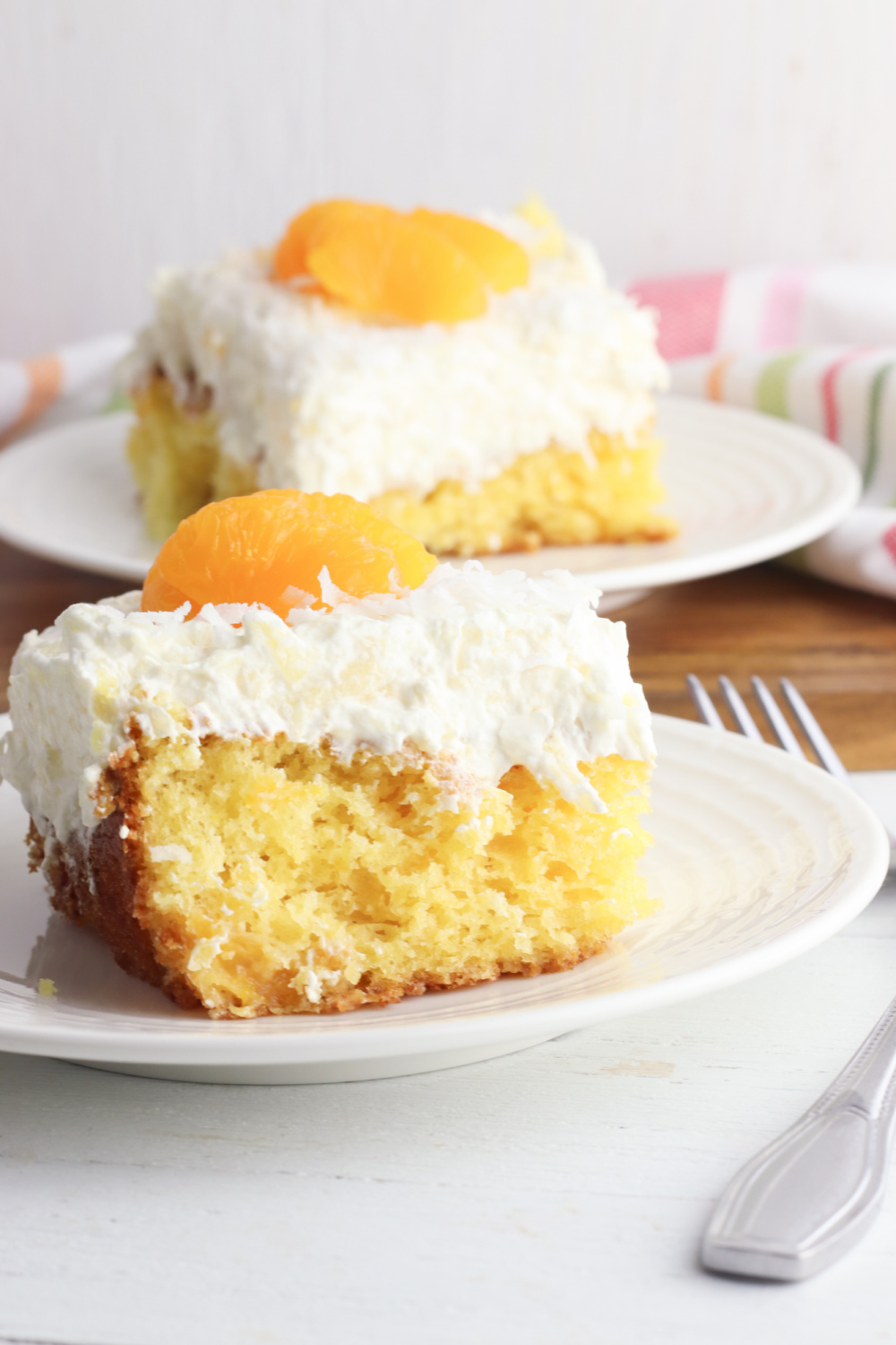 Mandarin Orange Pineapple Cake being served on a white plate.