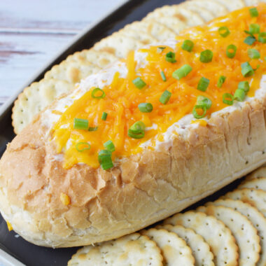 Mississippi Sin Dip being served with crackers for a game day party.