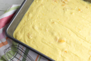 pour orange pineapple cake batter into pan