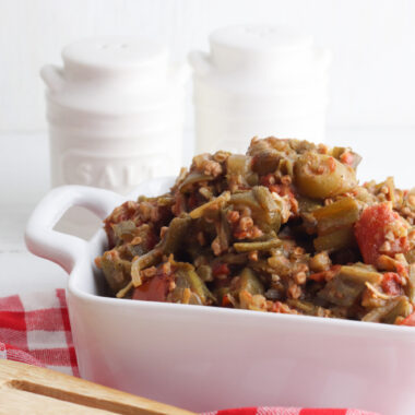 vegetarian smothered okra being served in a white dish.