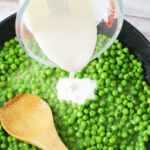 Pouring Cream Sauce over Peas
