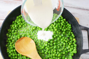 Pouring Cream Sauce over Peas