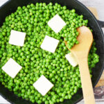 Stirring in butter to creamed peas.