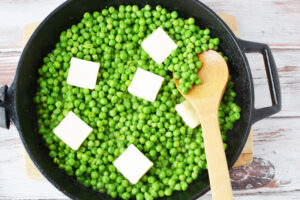 Stirring in butter to creamed peas.