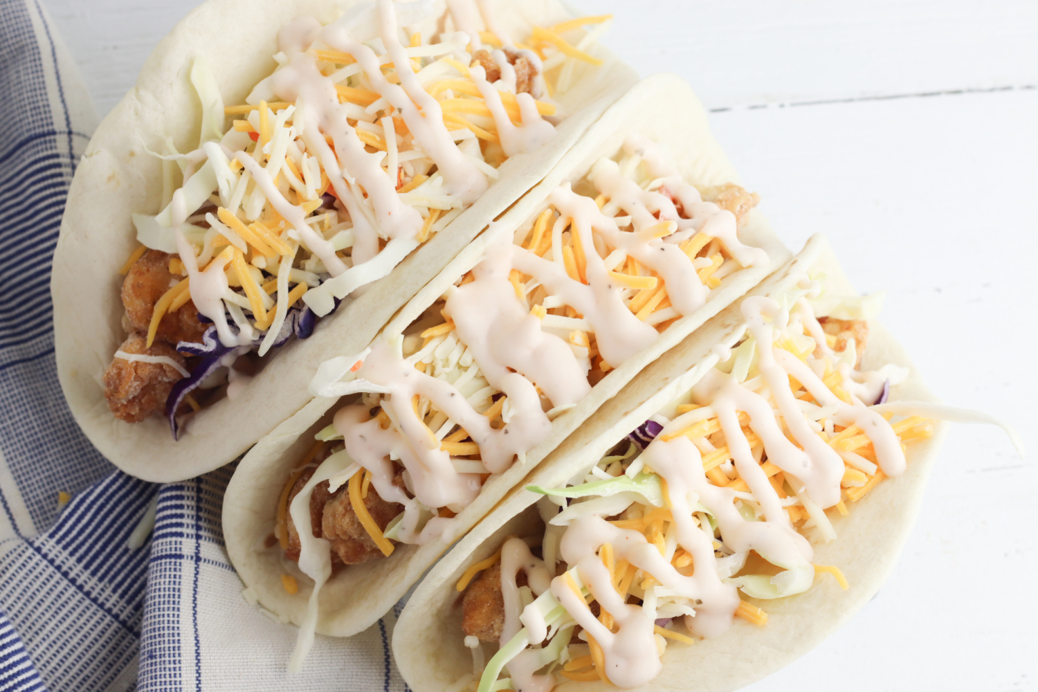 Fried Chicken Tacos with cheese and lettuce.