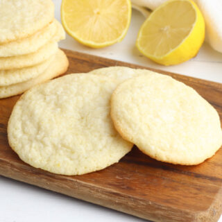 Meyer Lemon Cookies sitting on a counter with lemons.