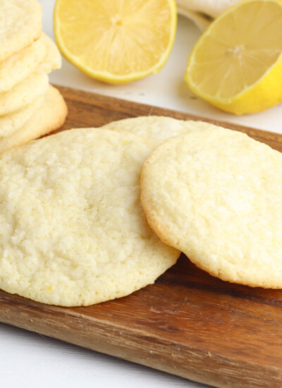 Meyer Lemon Cookies sitting on a counter with lemons.