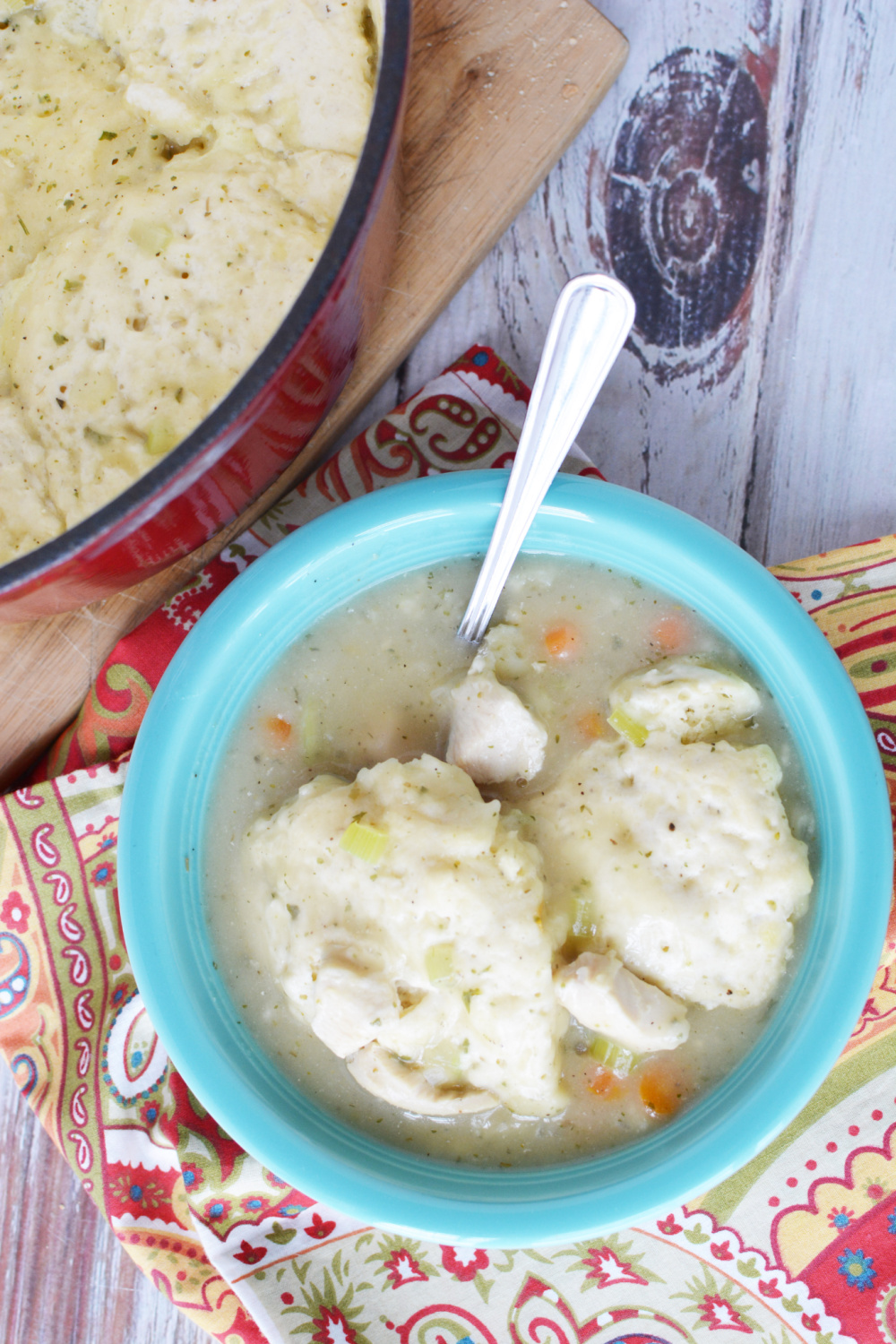 Easy Bisquick Chicken and Dumplings in a blue bowl with a spoon.