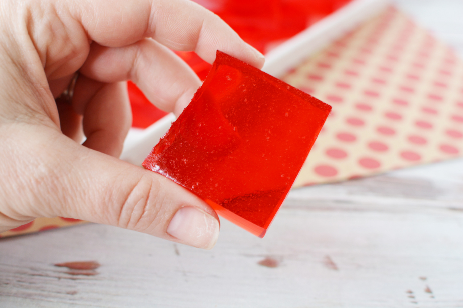 Easy Finger Jello being picked up by hand