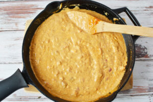 Stir chili cheese dip in skillet