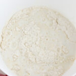 Pour in buttermilk into biscuits