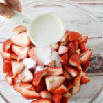 Add sugar to sliced strawberries