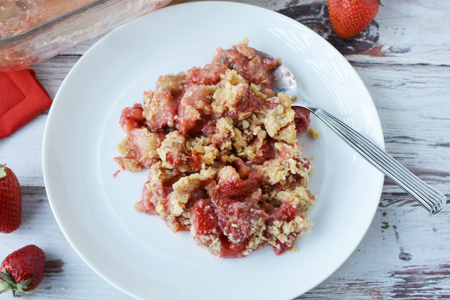 Easy strawberry crumble served on a white plate for dessert.