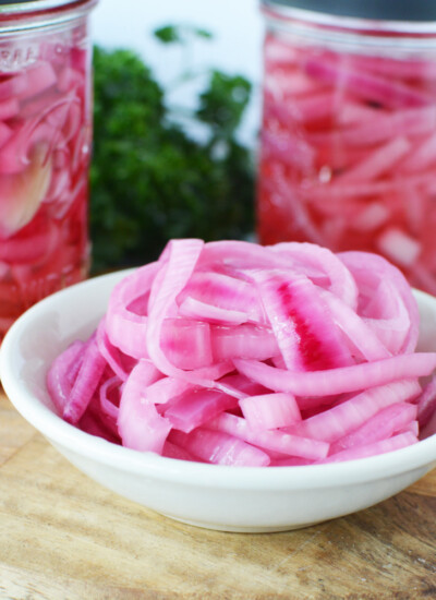 Sugar Free Pickled Red Onions on a counter with mason jars.