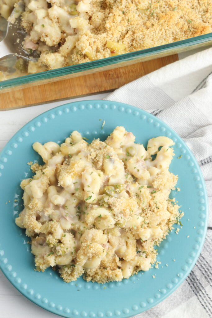 Tuna Noodle Casserole sitting on a table next to baking dish. 