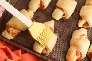 Brushing crescent rolls with butter