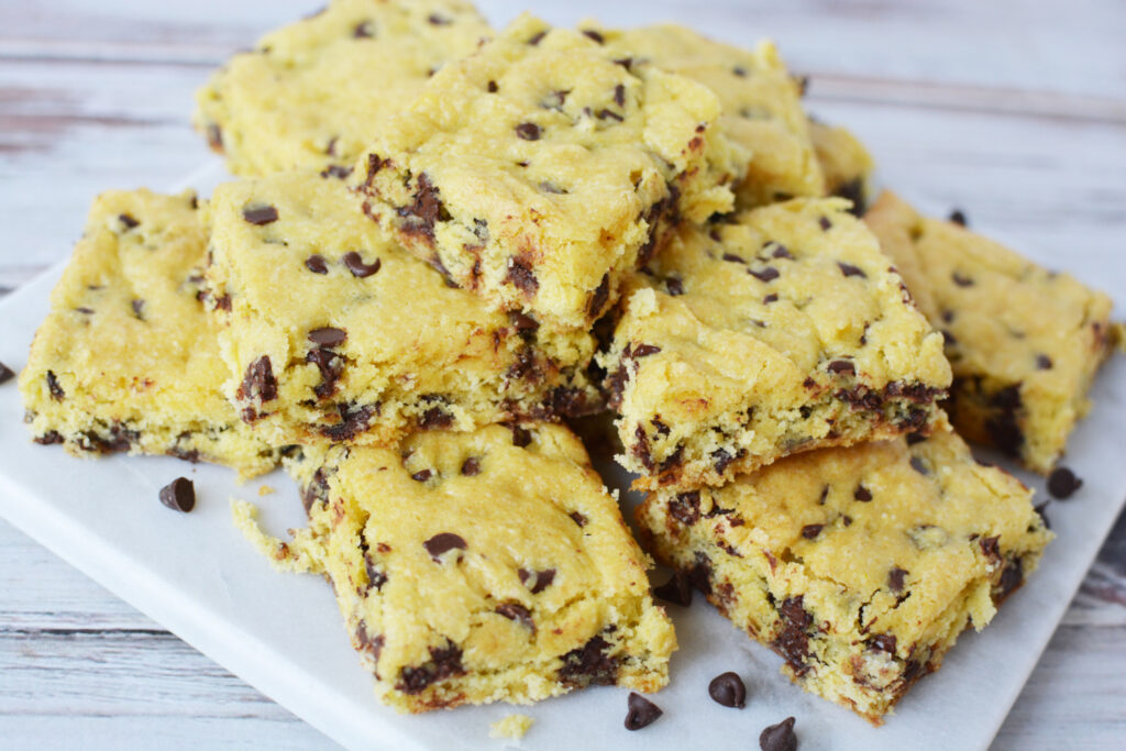 Cake Mix Cookie Bars piled on a white plate.