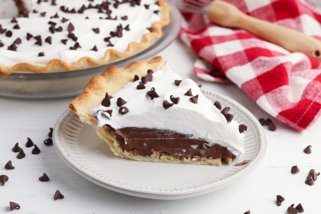 Chocolate Cream Pie being served on a white plate.
