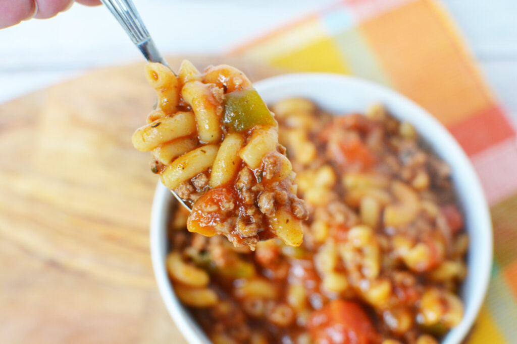 Easy American Goulash Recipe being served with a large spoon. 
