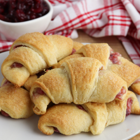 Cranberry Crescent Rolls stacked on a white plate.