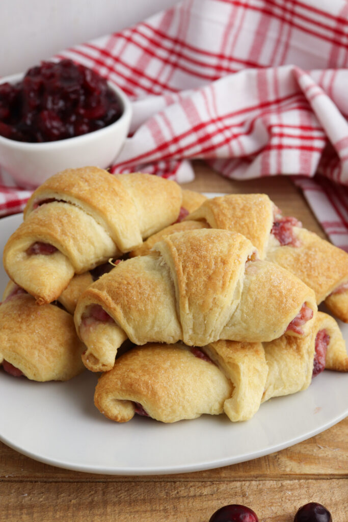 Cranberry Crescent Rolls with a bowl of cranberry sauce.