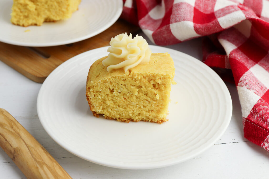 Honey Butter Cornbread being served on a white plate.