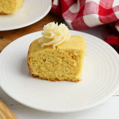 Honey Butter Cornbread being served on a white plate.