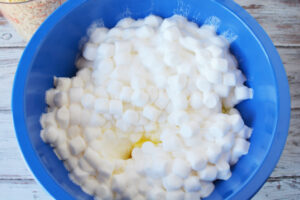Melt marshmallows and butter together.