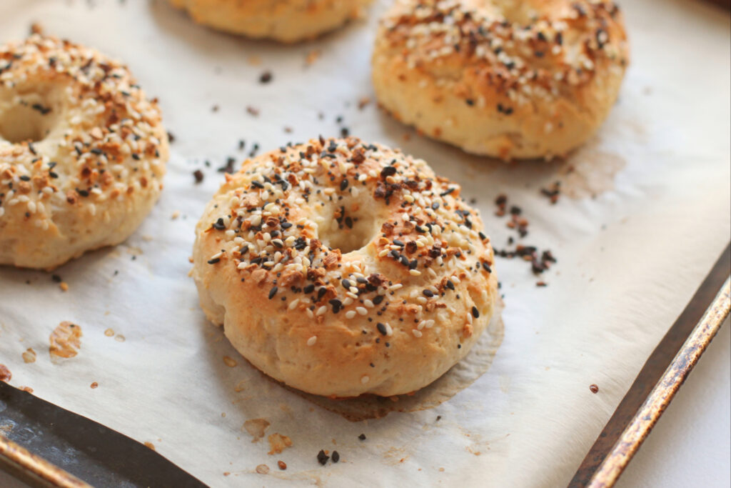 2 ingredient bagels on baking sheet.