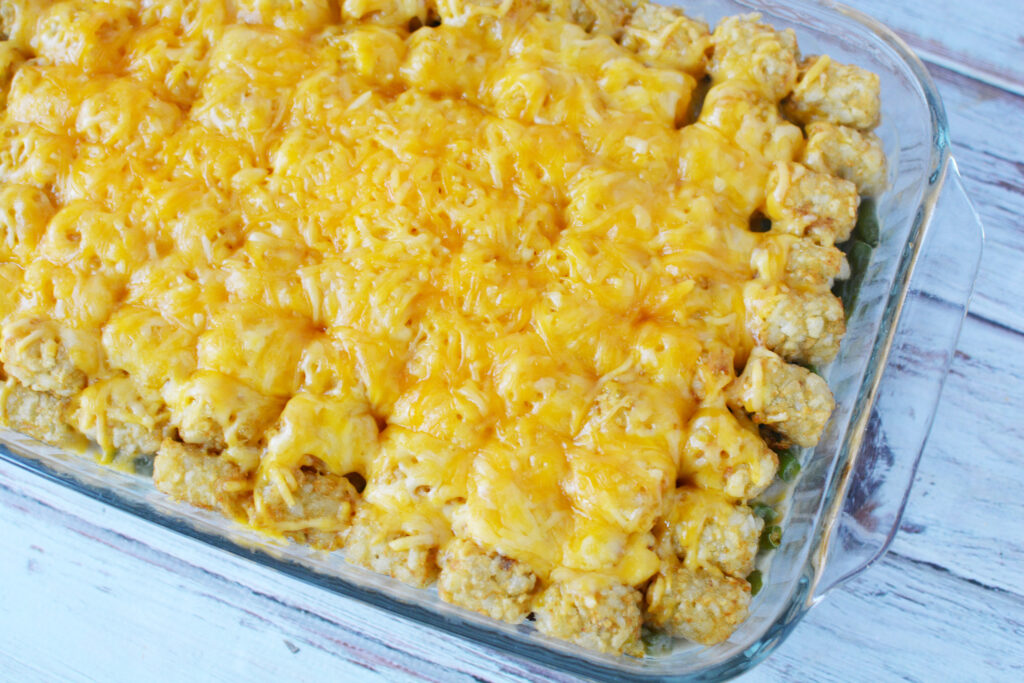 Tater Tot Casserole topped with cheese coming out of the oven.