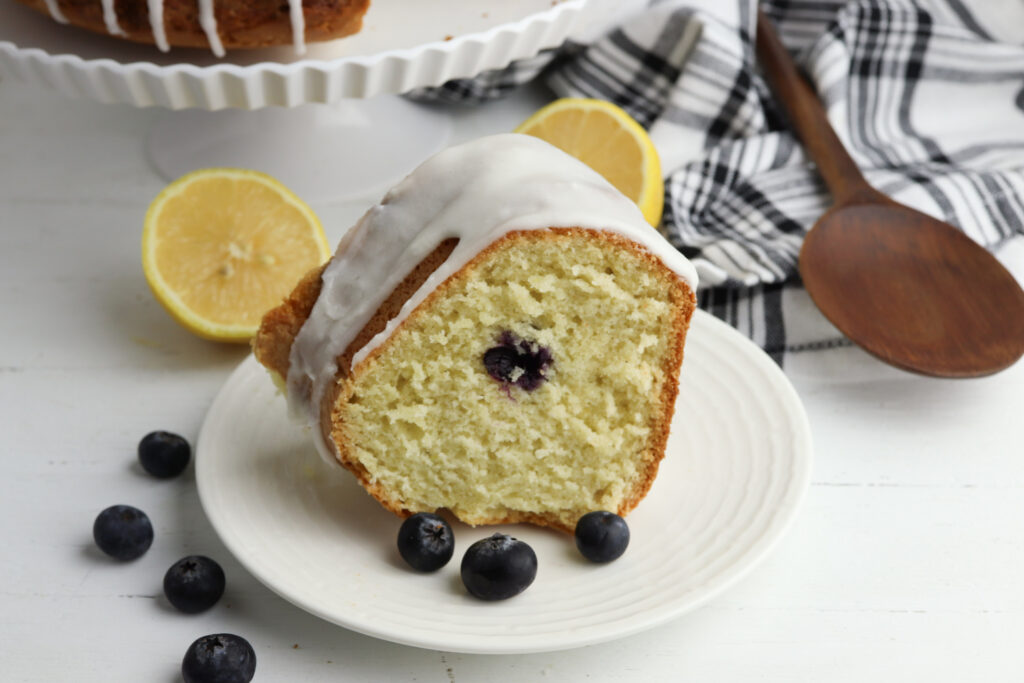 Lemon Blueberry Bundt Cake being served on a white plate.