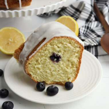 Lemon Blueberry Bundt Cake being served on a white plate.